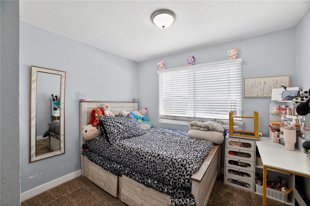 116 Doyle Avenue Redlands, CA 92374 - Photo 6 of 11 a bedroom with a bed and wooden floor