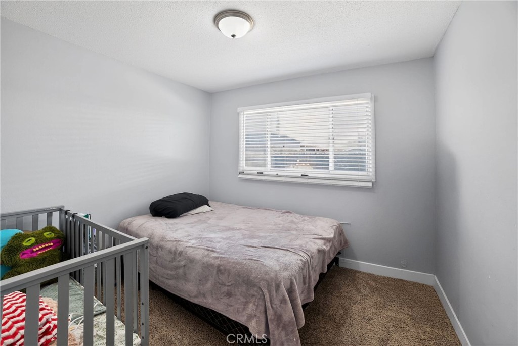 116 Doyle Avenue Redlands, CA 92374 - Photo 7 of 11 a bedroom with a bed and a window