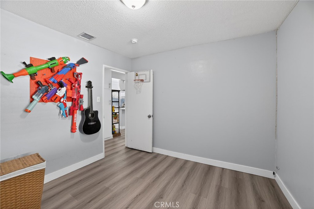 116 Doyle Avenue Redlands, CA 92374 - Photo 8 of 11 a view of an empty room with wooden floor and closet