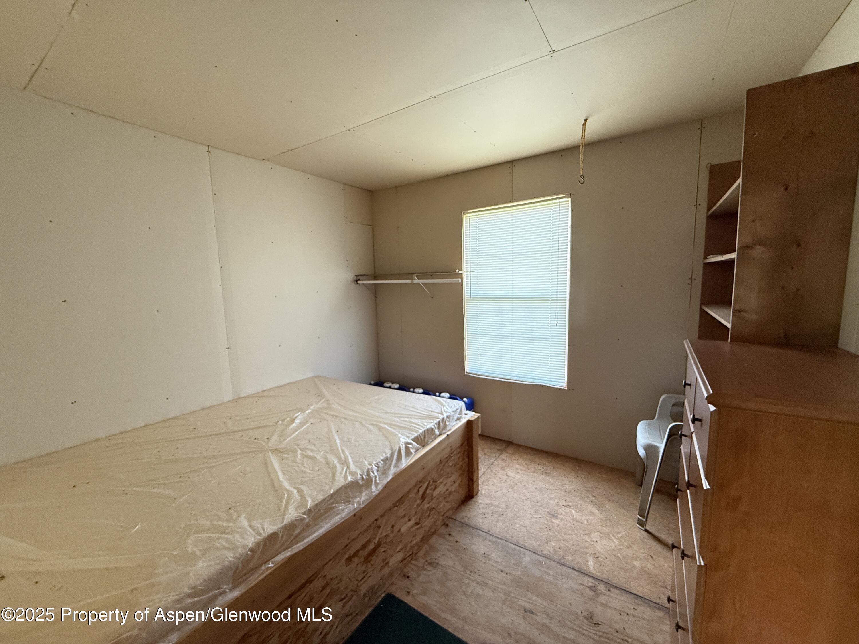 276 Sycamore Road, Unit LOT 288 Craig, CO 81625 - Photo 20 of 24 a bedroom with a bed and a window