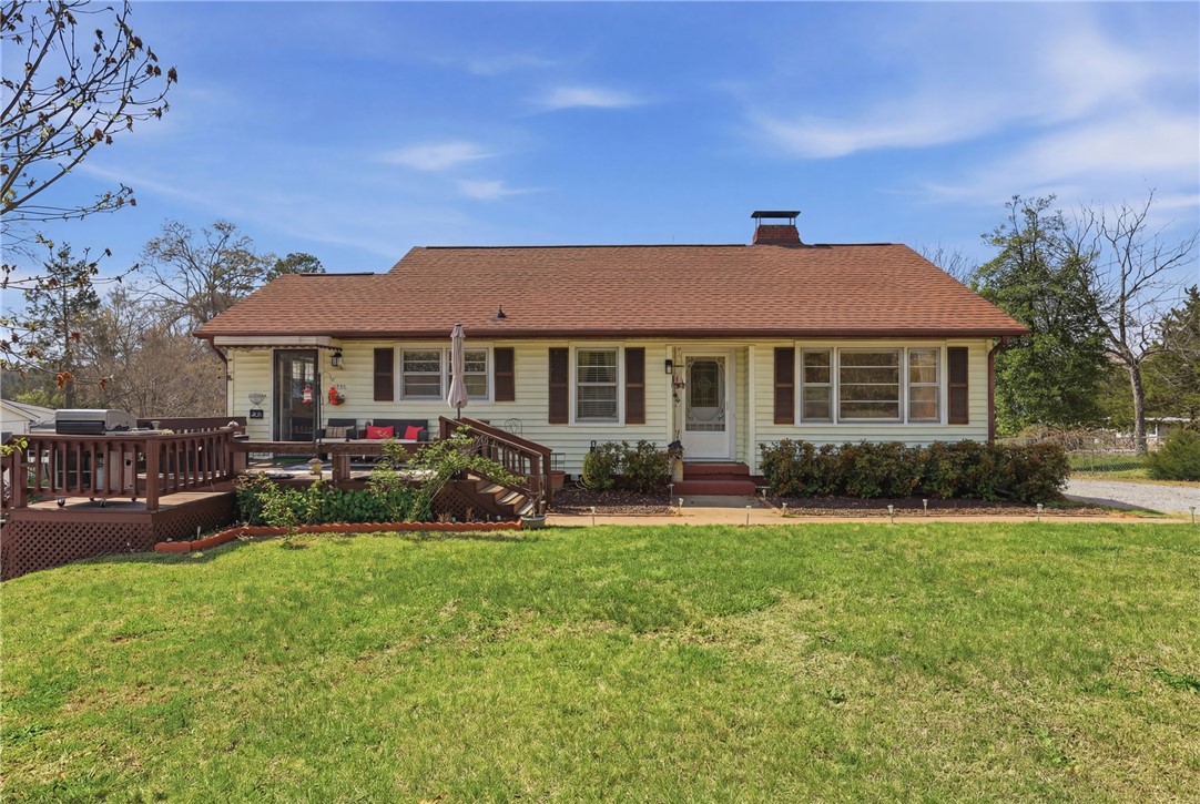 This charming home offers a welcoming facade with a spacious deck perfect for outdoor enjoyment.