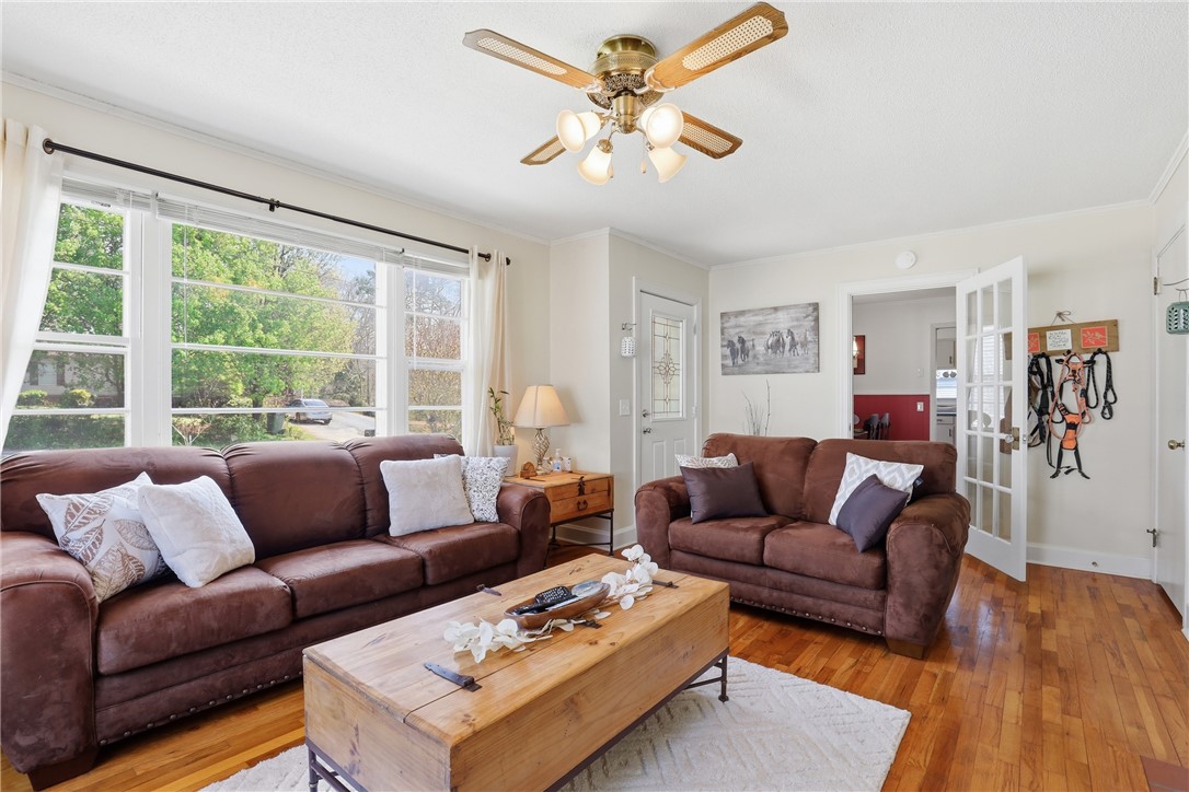 602 South Tugaloo Street Walhalla, SC 29691 - Photo 13 of 38 Bright and airy living area with abundant natural light and rich wood flooring.