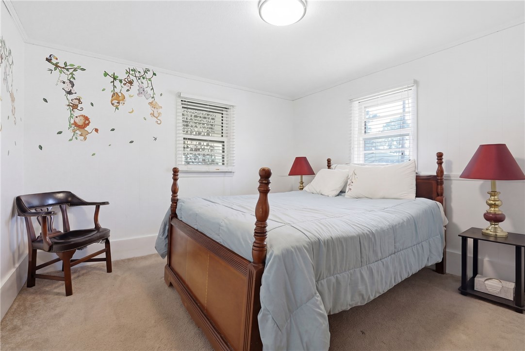 602 South Tugaloo Street Walhalla, SC 29691 - Photo 25 of 38 This cozy bedroom features comfortable carpet flooring and natural light through its windows.