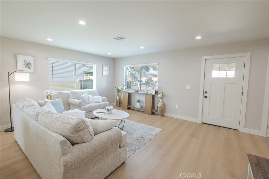 223 South Aprilia Avenue Compton, CA 90220 - Photo 4 of 46 a living room with furniture and a wooden floor