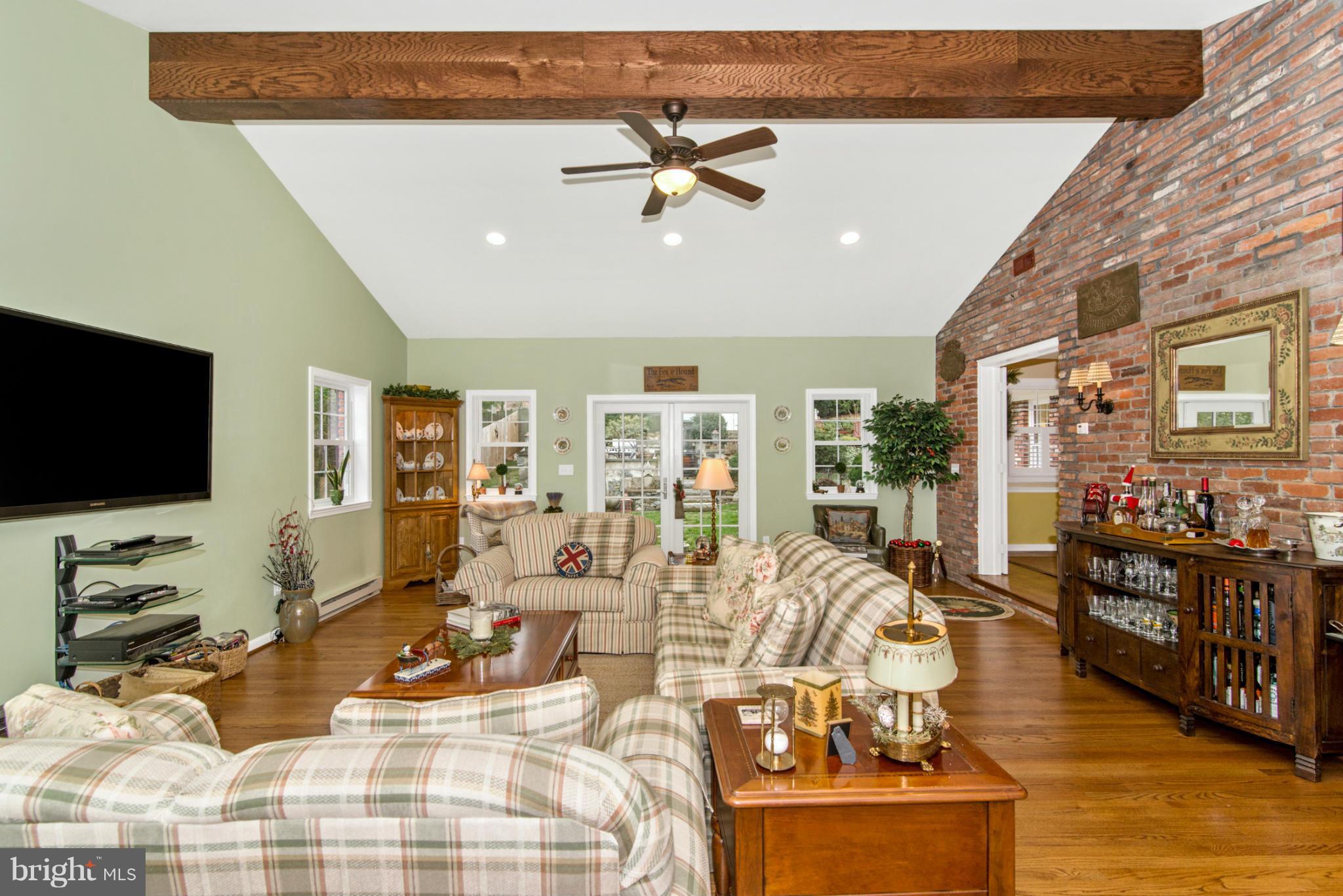 23901 Stringtown Road Clarksburg, MD 20871 - Photo 14 of 30 Large Beam and Brick Wall in Family Room