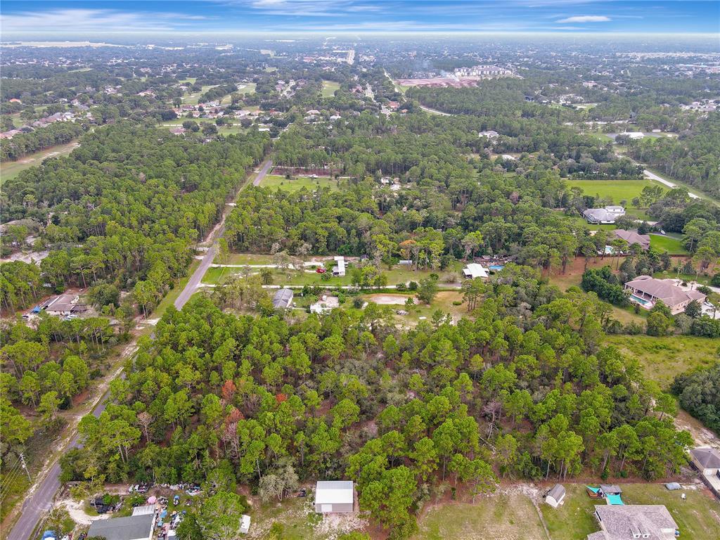 5411 Nodoc Road Spring Hill, FL 34609 - Photo 4 of 7 an aerial view of residential houses with outdoor space and trees
