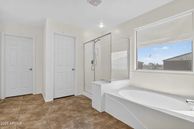 a spacious bathroom with a bathtub and a shower