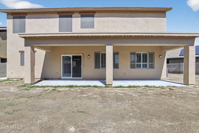 a view of a house with backyard and road