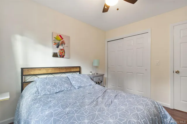 a bedroom with a bed and painting on the wall