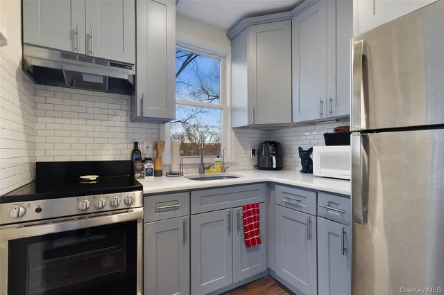 a kitchen with stainless steel appliances a stove a refrigerator sink and cabinets