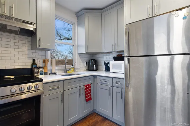 a kitchen with stainless steel appliances a refrigerator sink and cabinets