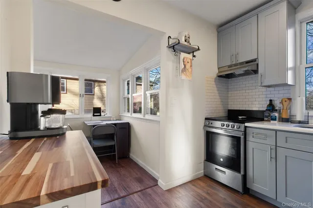 a kitchen with a sink a stove and cabinets