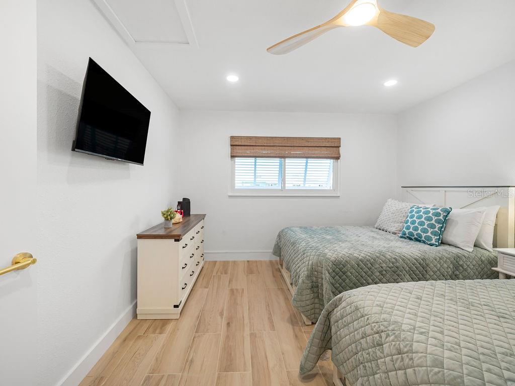 449 63rd Street Holmes Beach, FL 34217 - Photo 11 of 54 a bedroom with a bed and a flat screen tv