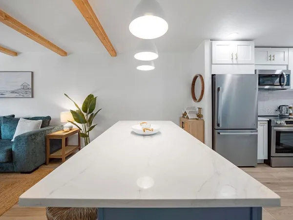 a kitchen with stainless steel appliances a refrigerator and a stove