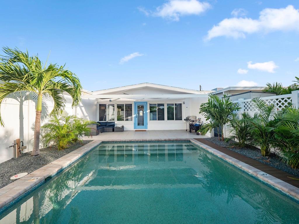 449 63rd Street Holmes Beach, FL 34217 - Photo 2 of 54 a view of house with swimming pool outdoor seating