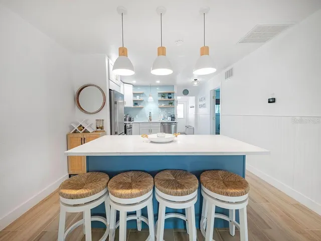 a kitchen with a dining table and chairs
