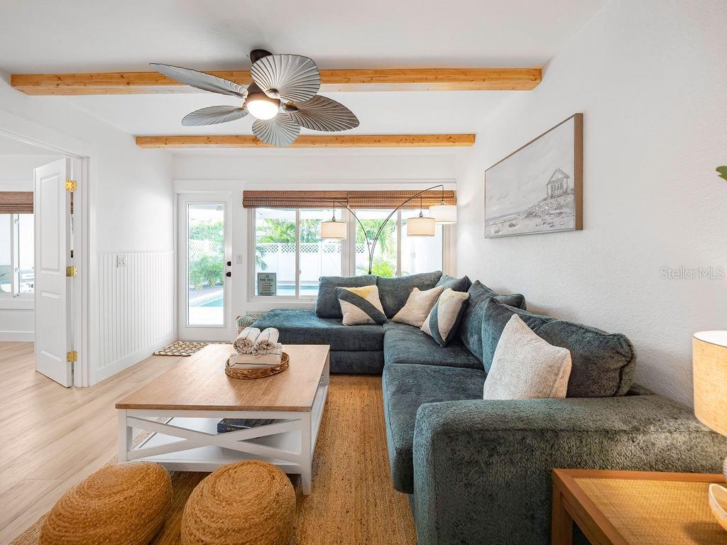 449 63rd Street Holmes Beach, FL 34217 - Photo 23 of 54 a living room with furniture and a chandelier