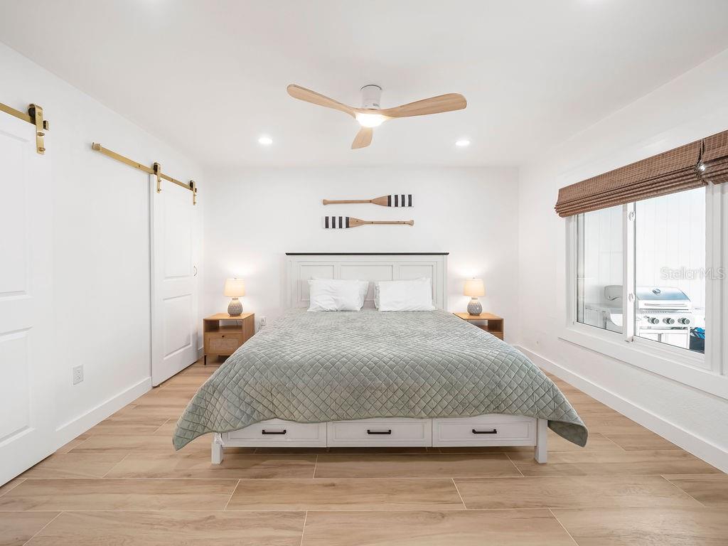 449 63rd Street Holmes Beach, FL 34217 - Photo 26 of 54 a bedroom with a bed and a large window
