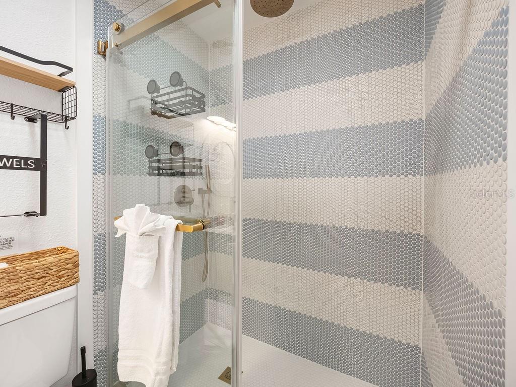 449 63rd Street Holmes Beach, FL 34217 - Photo 31 of 54 a bathroom with a tub and a shower