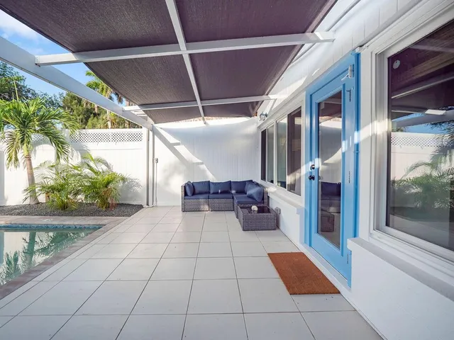 a view of a balcony with furniture and floor to ceiling window