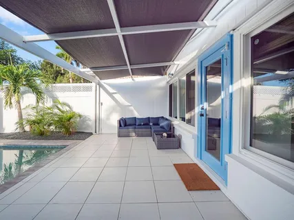 a view of a balcony with furniture and floor to ceiling window