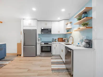 a kitchen with kitchen island a sink stainless steel appliances and counter space