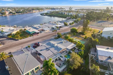 a view of house with a yard and potted plants