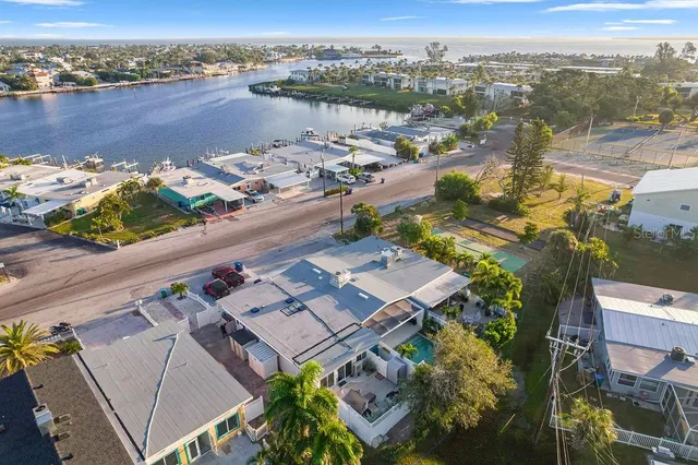 a view of house with a yard and potted plants