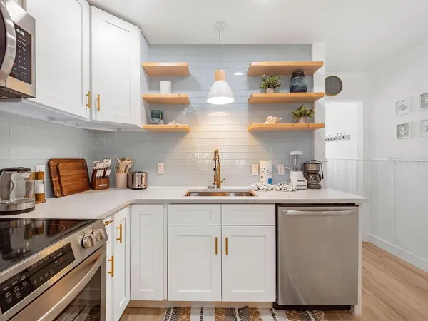 a kitchen with cabinets and appliances