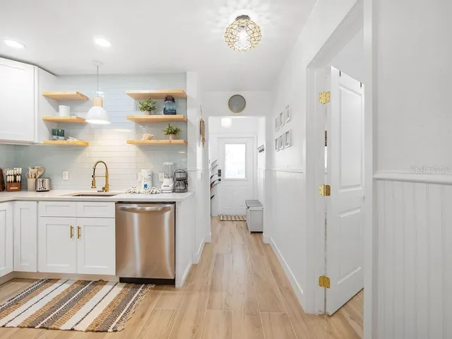 a spacious bathroom with a granite countertop sink a mirror and shower