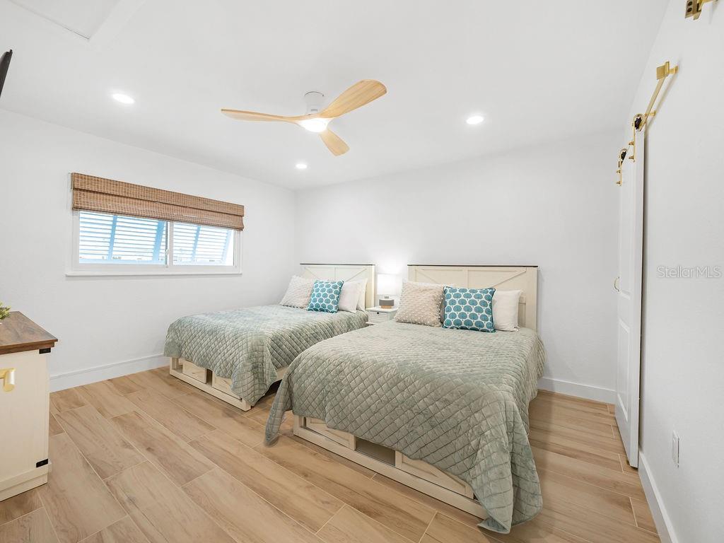 449 63rd Street Holmes Beach, FL 34217 - Photo 10 of 54 a bedroom with two beds and a window