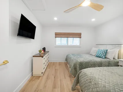 a bedroom with a bed and a flat screen tv