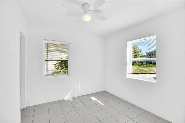 an empty room with windows and closet