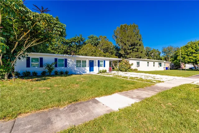a view of a house with swimming pool and a yard