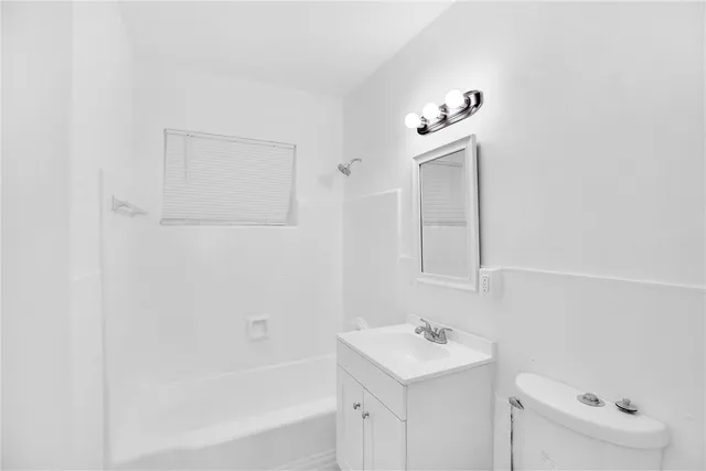 a bathroom with a bathtub sink vanity and mirror