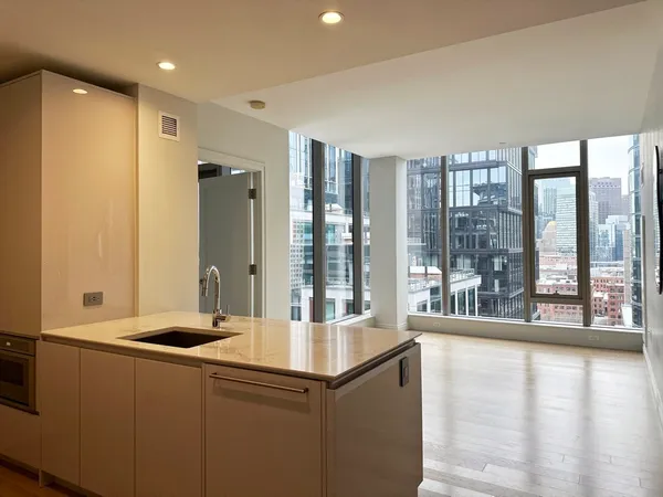 a room with a large window and a sink