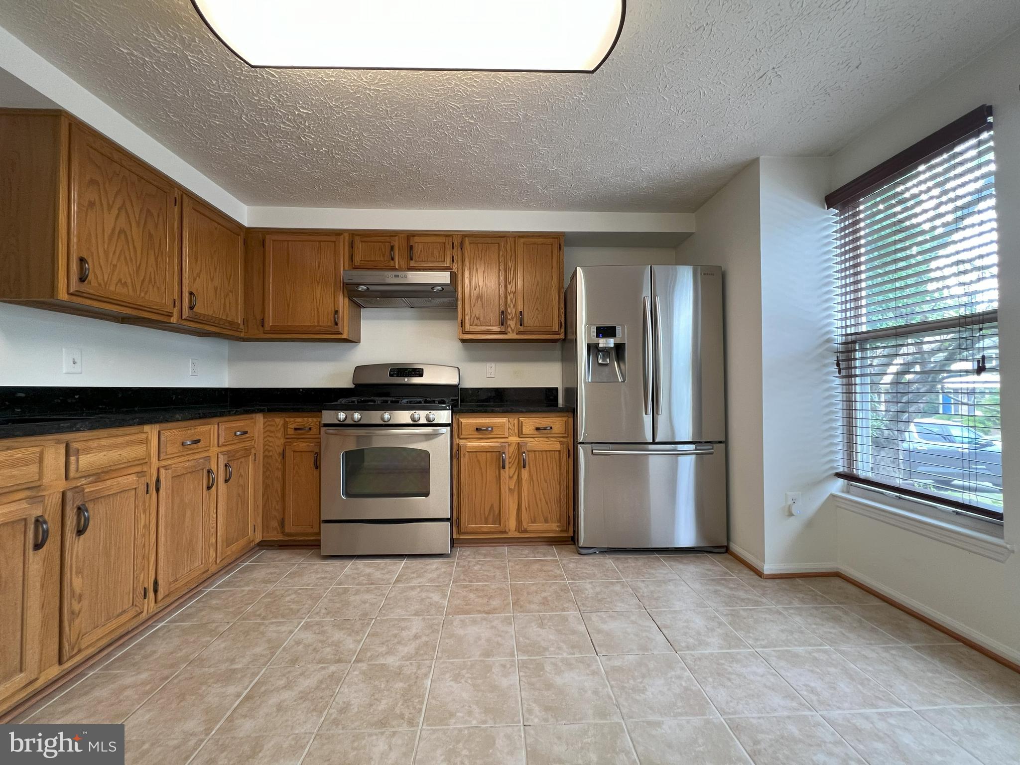 14027 Great Notch Terrace North Potomac, MD 20878 - Photo 4 of 27 a kitchen with a stove and a refrigerator