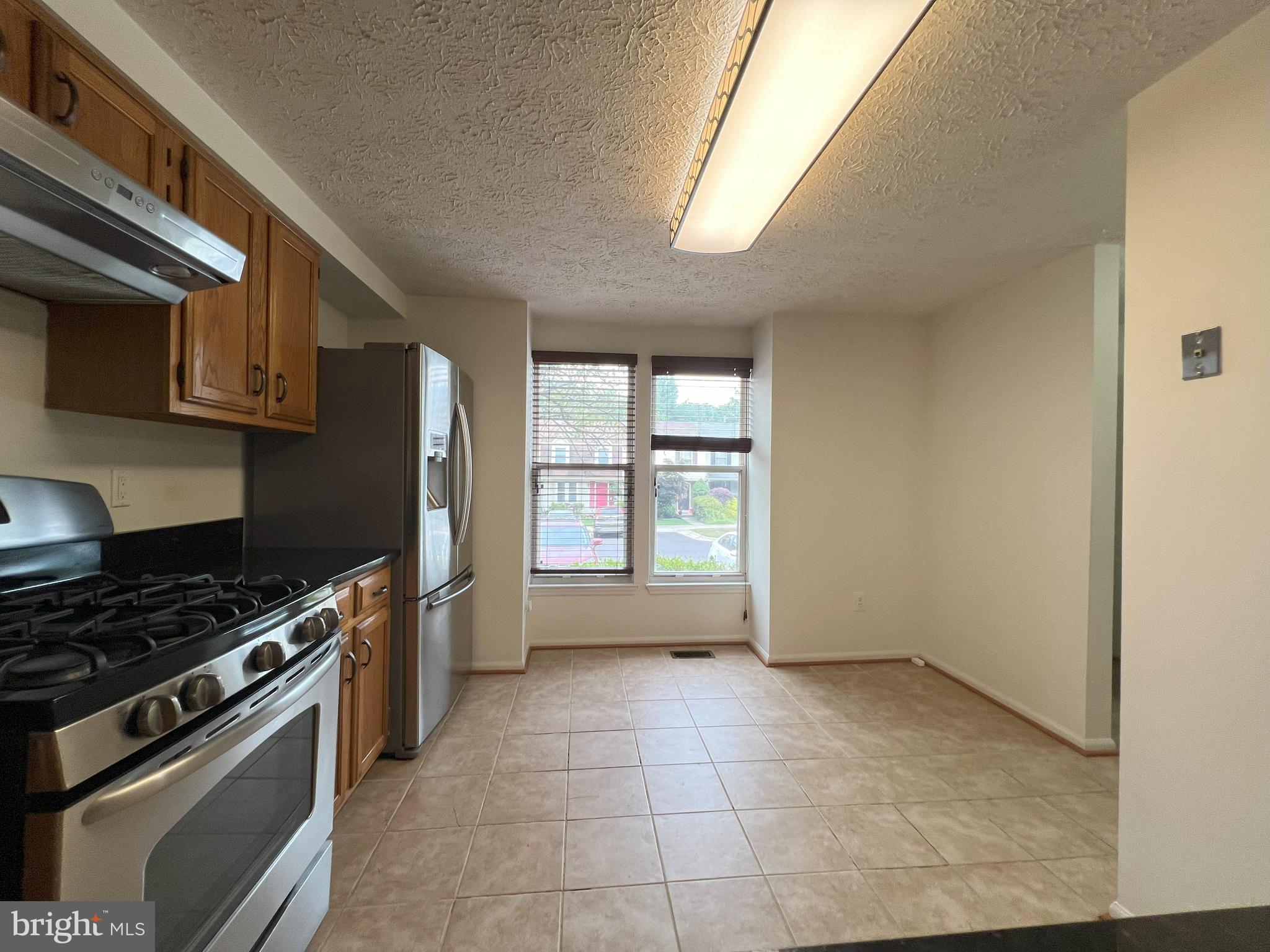 14027 Great Notch Terrace North Potomac, MD 20878 - Photo 5 of 27 a kitchen with a stove a fridge and a sink