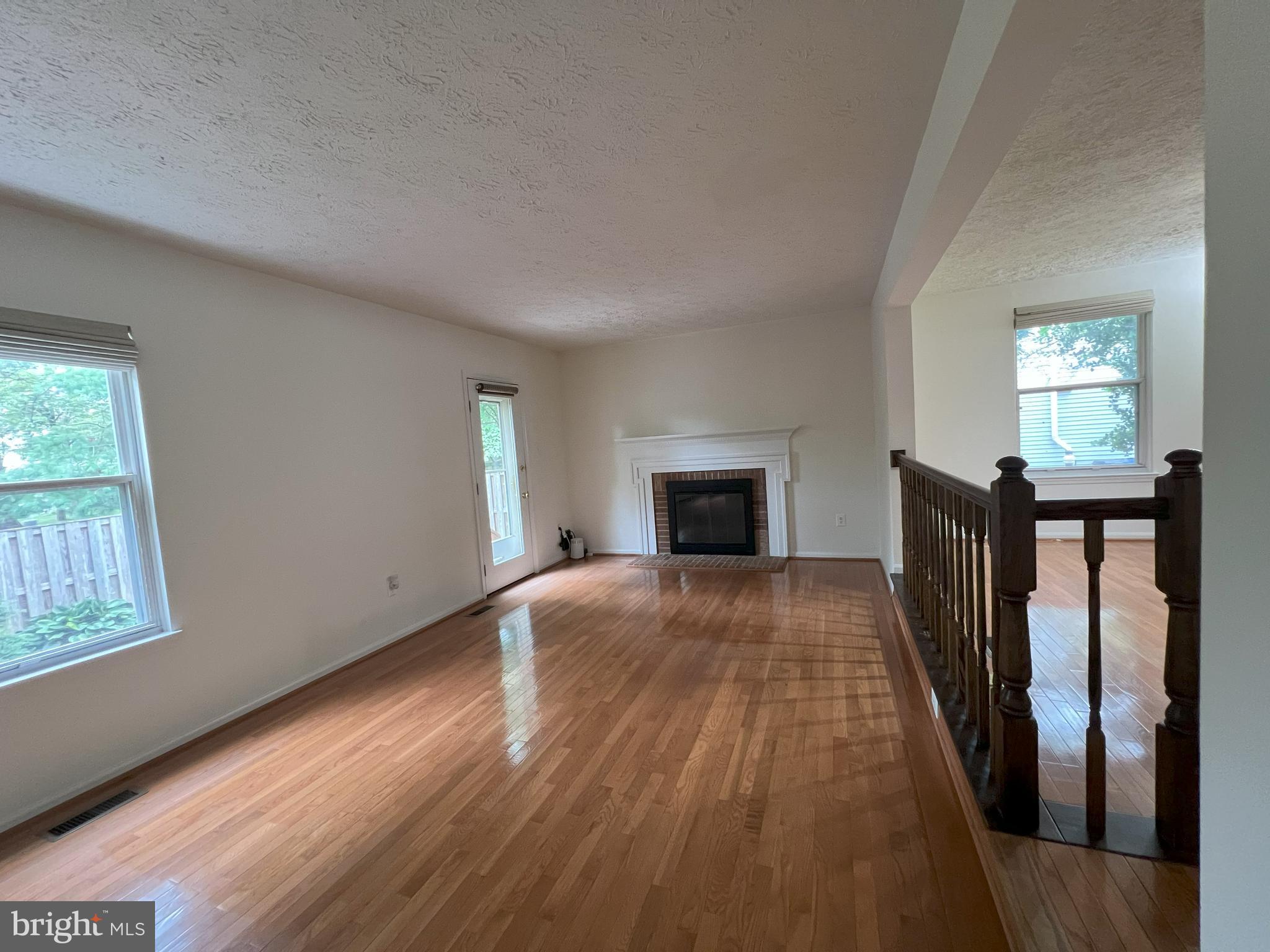 14027 Great Notch Terrace North Potomac, MD 20878 - Photo 7 of 27 a view of empty room with wooden floor and fireplace