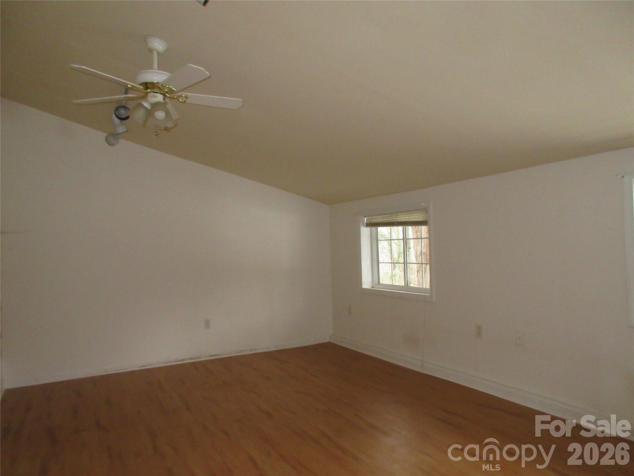 31 Ford Ridge Lane Columbus, NC 28722 - Photo 19 of 21 an empty room with a window and a chandelier fan