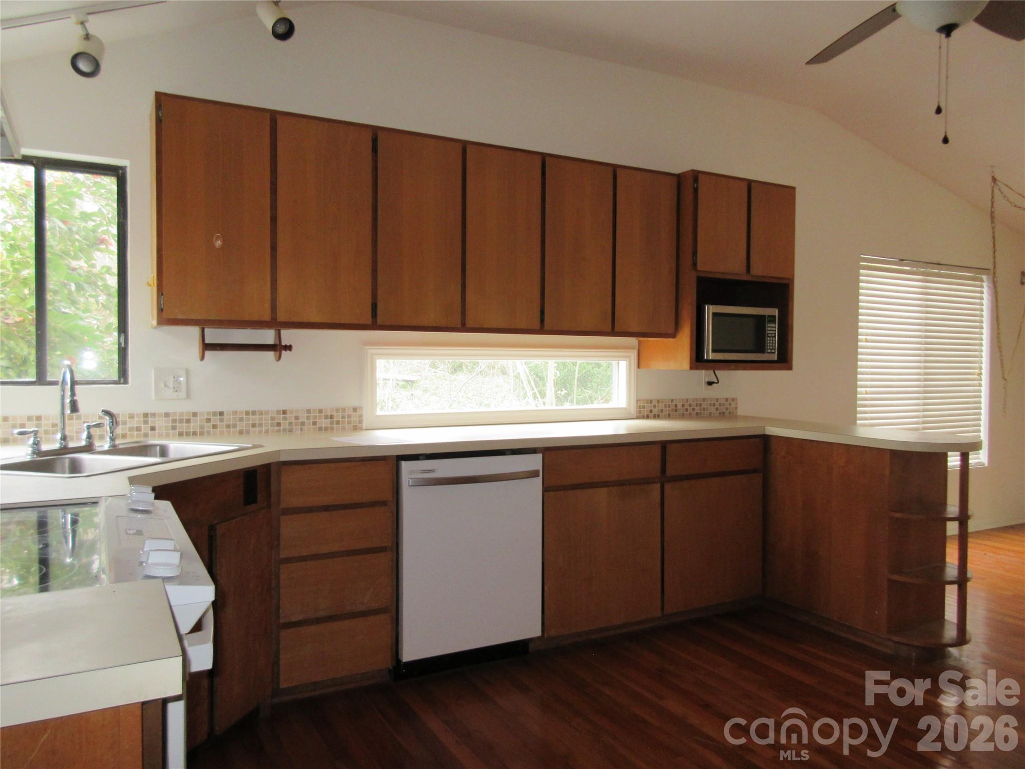 31 Ford Ridge Lane Columbus, NC 28722 - Photo 3 of 21 a kitchen with granite countertop wooden cabinets a sink and dishwasher