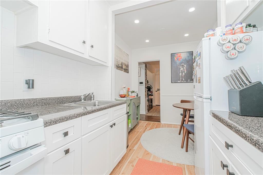 2140 Knapp Street, Unit 5H Brooklyn, NY 11229 - Photo 13 of 21 a spacious bathroom with a granite countertop sink mirror and vanity