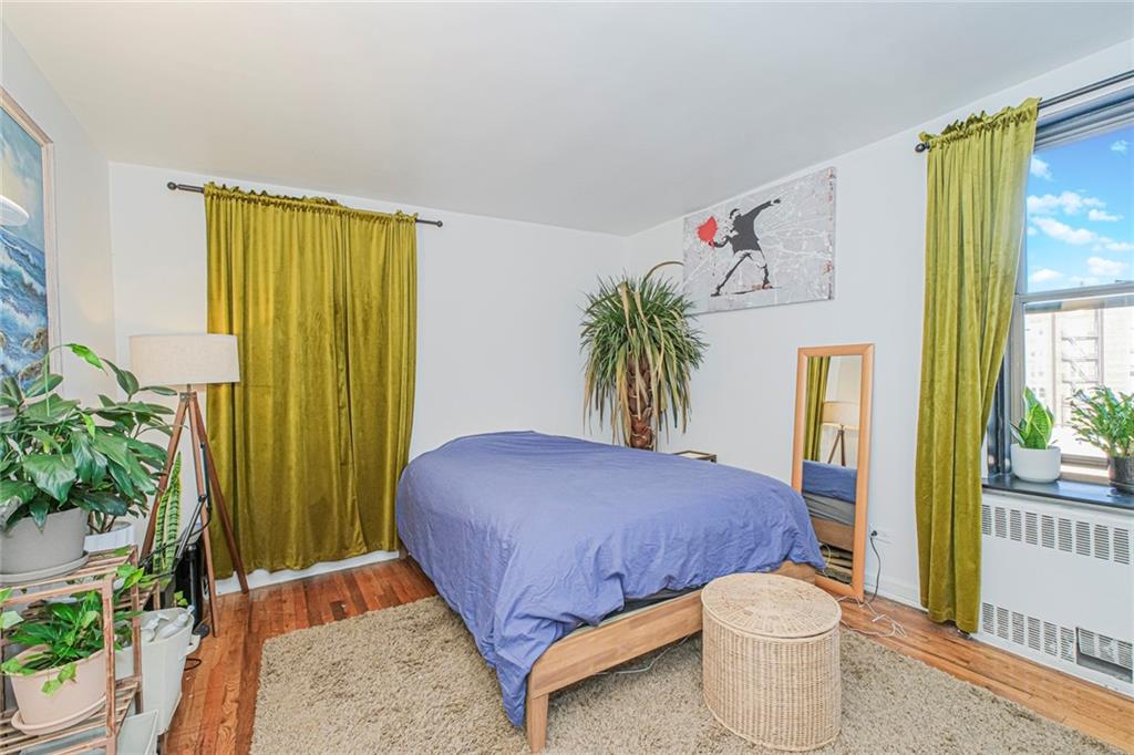 2140 Knapp Street, Unit 5H Brooklyn, NY 11229 - Photo 17 of 21 a bedroom with a bed and a potted plant