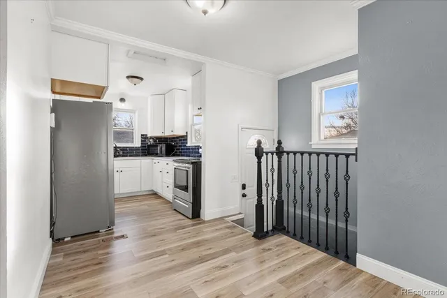a kitchen with granite countertop a refrigerator and a stove