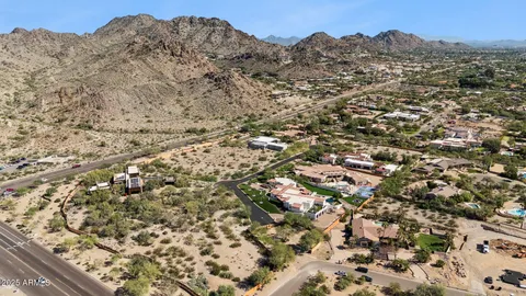 an aerial view of a residential houses with city view