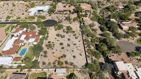 an aerial view of residential houses with yard