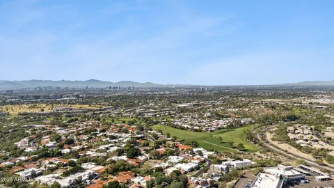an aerial view of residential building and trees around