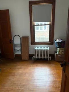 a view of a room with a window and a wooden floor
