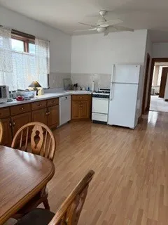 a kitchen with a table chairs sink and cabinets