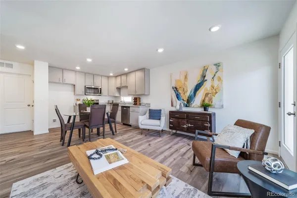 a living room with furniture and kitchen view